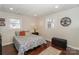 Bedroom with wood floors, patterned bedding, and two windows with natural light at 170 Woodcrest Rd, Mooresville, NC 28115