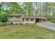 Charming split-level home featuring a well-manicured lawn, painted brick, and an attached carport at 170 Woodcrest Rd, Mooresville, NC 28115