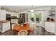Modern kitchen featuring stainless steel appliances, white cabinetry, and access to outdoor deck at 170 Woodcrest Rd, Mooresville, NC 28115
