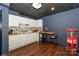 Basement kitchenette with white cabinets, mosaic backsplash, and adjacent dining table and popcorn machine at 170 Woodcrest Rd, Mooresville, NC 28115