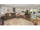 Bright, open-concept living area featuring modern furnishings, a cozy fireplace, and access to the kitchen at 170 Woodcrest Rd, Mooresville, NC 28115