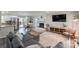 Bright, open-concept living area featuring modern furnishings, a cozy fireplace, and access to the kitchen at 170 Woodcrest Rd, Mooresville, NC 28115