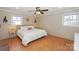Bright bedroom with natural light, hardwood floors, and a ceiling fan at 170 Woodcrest Rd, Mooresville, NC 28115