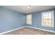 Charming bedroom with two windows and blue walls at 17613 Shasta Daisy Cir, Davidson, NC 28036