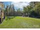 Large backyard with grassy lawn and a partially visible wooden picnic table at 2091 & 2095 Catawba River Rd, Fort Lawn, SC 29714