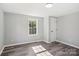 Well-lit bedroom with grey walls, wood-look vinyl flooring, and a window at 2091 & 2095 Catawba River Rd, Fort Lawn, SC 29714