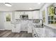 Bright kitchen with white cabinets, granite countertops, and a double sink at 2091 & 2095 Catawba River Rd, Fort Lawn, SC 29714