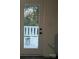 Back porch featuring door out to porch and greenery beyond, an unfinished space at 211 Brooklyn Ave, Lancaster, SC 29720