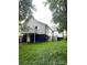 Spacious backyard with a white house, stairs, and green grass at 211 Brooklyn Ave, Lancaster, SC 29720