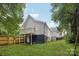 Expansive backyard featuring a covered porch/balcony, stairs and lush green lawn, ideal for outdoor enjoyment at 211 Brooklyn Ave, Lancaster, SC 29720