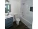Bathroom featuring a vanity sink, toilet, and shower with white tile at 211 Brooklyn Ave, Lancaster, SC 29720