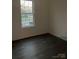 Bedroom with hardwood floors, neutral walls, a double hung window, and a wall plug at 211 Brooklyn Ave, Lancaster, SC 29720