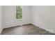 Cozy bedroom with wood-look flooring, natural light, and a serene atmosphere at 211 Brooklyn Ave, Lancaster, SC 29720