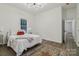 Bright bedroom with a vintage rug, hardwood floors, and a window with a wooded view at 211 Brooklyn Ave, Lancaster, SC 29720
