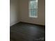 A charming bedroom space with natural light from the window at 211 Brooklyn Ave, Lancaster, SC 29720
