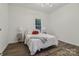 Bright bedroom with a vintage rug, hardwood floors, and a window with a wooded view at 211 Brooklyn Ave, Lancaster, SC 29720
