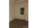Bedroom featuring light walls, wood-look floors, and a window at 211 Brooklyn Ave, Lancaster, SC 29720