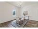 Bright dining room featuring hardwood floors, a decorative rug, and abundant natural light from the large window at 211 Brooklyn Ave, Lancaster, SC 29720