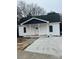 Charming single-story home featuring white siding, a dark green roof, and a welcoming front porch at 211 Brooklyn Ave, Lancaster, SC 29720