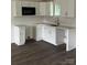 Modern kitchen with white cabinets, tile backsplash, and dark wood flooring at 211 Brooklyn Ave, Lancaster, SC 29720