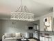 Bright living room featuring a stylish chandelier, couch, and kitchen view at 211 Brooklyn Ave, Lancaster, SC 29720