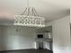 Bright living room featuring a stylish chandelier, couch, and kitchen view at 211 Brooklyn Ave, Lancaster, SC 29720