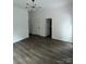 Spacious, empty living room with hardwood floors and ample natural light at 211 Brooklyn Ave, Lancaster, SC 29720