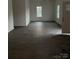 A very large and open living space with two windows for natural lighting at 211 Brooklyn Ave, Lancaster, SC 29720