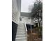 View of the rear exterior featuring stairs leading to the back door and a charming elevated deck at 211 Brooklyn Ave, Lancaster, SC 29720