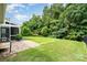 Well-maintained backyard featuring a paver patio, lush lawn, and access to a screened in porch at 2201 Bluebell Way, Tega Cay, SC 29708