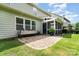 Backyard patio with green grass, screened-in porch and green siding at 2201 Bluebell Way, Tega Cay, SC 29708