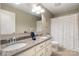 Bright bathroom with double sinks, granite countertop, and a shower/tub with blue and white curtain at 2201 Bluebell Way, Tega Cay, SC 29708
