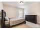 Bedroom featuring a bed, dresser, carpet, and a window for natural light at 2201 Bluebell Way, Tega Cay, SC 29708