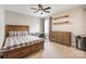 Bedroom featuring a ceiling fan, window, wooden furniture and decor at 2201 Bluebell Way, Tega Cay, SC 29708