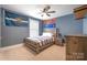 Bedroom featuring a ceiling fan, window, and sports-themed decor at 2201 Bluebell Way, Tega Cay, SC 29708