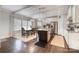 Open dining area featuring a light-filled space with a dark-wood kitchen island and views of the stainless fridge at 2201 Bluebell Way, Tega Cay, SC 29708