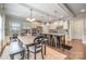 An open-concept space featuring a wooden dining table adjacent to a kitchen island with barstool seating at 2201 Bluebell Way, Tega Cay, SC 29708