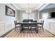 Formal dining room featuring tray ceiling, stylish chandelier, and elegant wainscoting details at 2201 Bluebell Way, Tega Cay, SC 29708