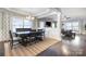 An open-concept dining area with a dark wood table, stylish rug, and views into the adjacent living room at 2201 Bluebell Way, Tega Cay, SC 29708