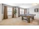 Game room with a pool table, carpet, and two large windows at 2201 Bluebell Way, Tega Cay, SC 29708