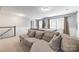 Spacious game room features a comfortable sofa, pool table, and two windows at 2201 Bluebell Way, Tega Cay, SC 29708