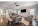 Bright living room featuring hardwood floors, ceiling fan, and multiple windows with neutral drapes at 2201 Bluebell Way, Tega Cay, SC 29708