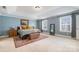 This main bedroom includes a tray ceiling, carpet, and two windows at 2201 Bluebell Way, Tega Cay, SC 29708