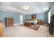 Spacious main bedroom with tray ceilings, carpet, and blue walls at 2201 Bluebell Way, Tega Cay, SC 29708