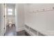 Mudroom featuring coat hooks, built-in bench with storage, and access to the powder room at 2201 Bluebell Way, Tega Cay, SC 29708