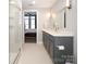 Clean bathroom with gray vanity, a walk-in shower, and a view of bedroom at 2401 Euclid Ave # 110, Charlotte, NC 28203
