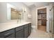 Elegant bathroom with gray vanity, a walk-in shower, and large closet at 2401 Euclid Ave # 110, Charlotte, NC 28203
