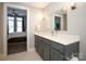 Modern bathroom with gray vanity, quartz countertop, and walk-in shower at 2401 Euclid Ave # 110, Charlotte, NC 28203