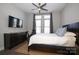 Spacious bedroom with a large TV, king-size bed, and ample natural light at 2401 Euclid Ave # 110, Charlotte, NC 28203