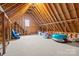 Unfinished attic space with wood framing and a small window at 2498 Smith Harbour Dr, Denver, NC 28037